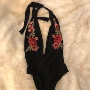 V cut black body suit, floral pattern